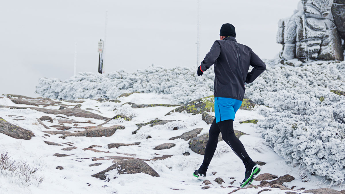 Warm Dressed Runner Running On The Frozen Snowy Trail In Cold Wi Warm Dressed Runner Running On The Frozen Snowy Trail In Cold Wi