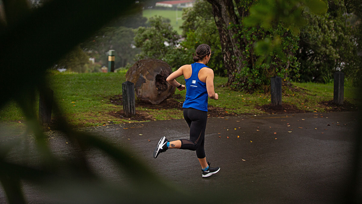 Contraception And Female Performance A Woman Running On A Multi User Path In The Rain