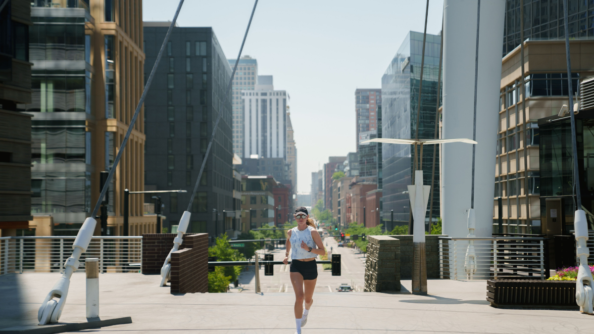 Woman Running Through Urban Area Affected By Poor Air Quality.